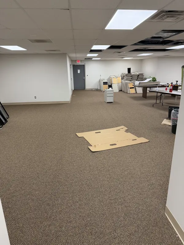Commercial carpet installation in progress in a large office